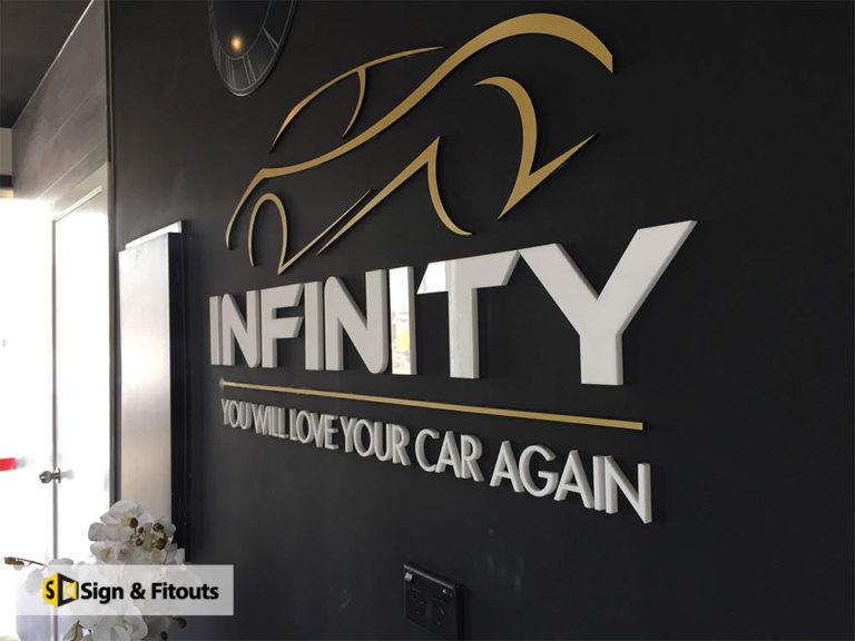Infinity You Will Love Your Car Again 3D logo and lettering on a black reception wall in Preston