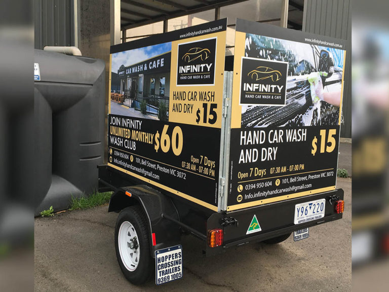 Infinity Car Wash & Cafe printed trailer sign with prices and opening hours in Preston